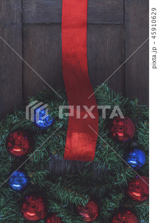 Christmas wreath on the door of a wooden house Christmas wreath on the door of a wooden house 45910629