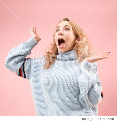 Beautiful woman looking suprised isolated on pink 45911546