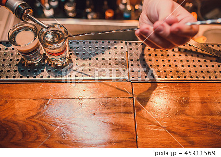 Bartender making shots on black bar with reflection. 45911569