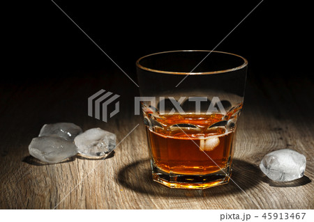 Glass of alcoholic drink with ice cubes 45913467