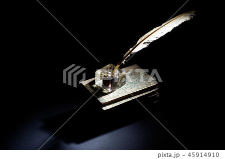 background with old ink bottle, books, and quill 45914910