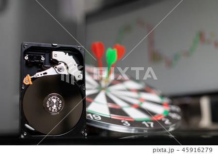hard drive in background of dart Board with Darts at targets and graphics 45916279
