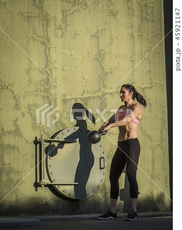 Woman exercising with kettlebell 45921147