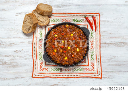 Pan of Texas chili on white wooden background. Pan of Texas chili on white wooden background. 45922193