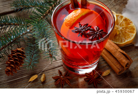 Mulled wine in a glass on a wooden background Mulled wine in a glass on a wooden background 45930067