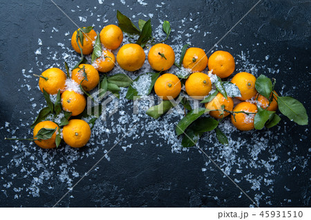 Photo of tangerines on black table Photo of tangerines on black table 45931510