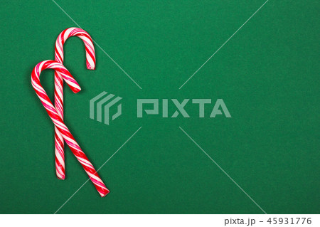 Christmas candy canes on green background. Christmas candy canes on green background. 45931776