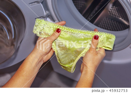 Lace panties in hands for laundry 45932753