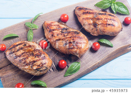 Grilled chicken breast fillet with basil tomatoes 45935973