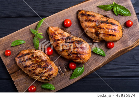 Grilled chicken breast fillet with basil tomatoes Grilled chicken breast fillet with basil tomatoes 45935974