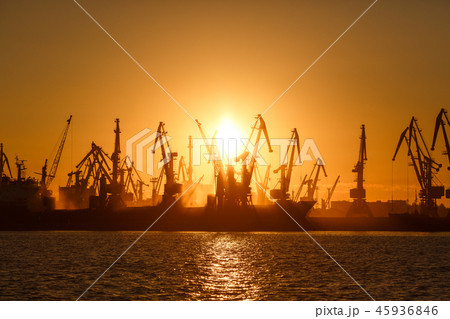 Many big cranes silhouette in the port of Azov sea Many big cranes silhouette in the port of Azov sea 45936846