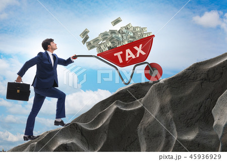 Businessman pushing tax wheelbarrow uphill Businessman pushing tax wheelbarrow uphill 45936929