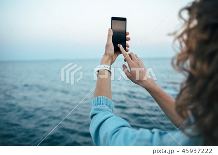 Young woman touching screen taking photo Young woman touching screen taking photo 45937222