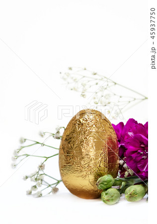 Golden egg and fuchsia flowers on white background Golden egg and fuchsia flowers on white background 45937750