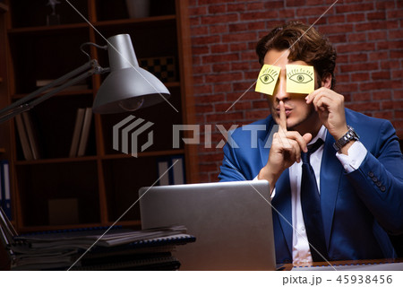 Young businessman working in the office at night  45938456