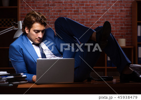 Young businessman working in the office at night  45938479