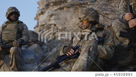 Armed soldiers checking their equipment Armed soldiers checking their equipment 45938993