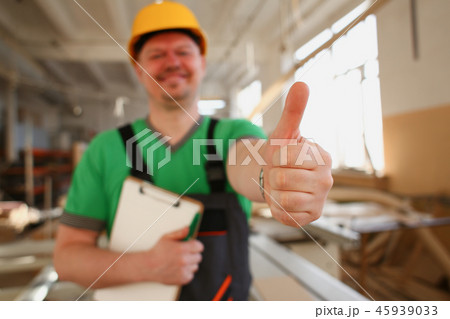 Smiling worker in yellow helmet show confirm sign 45939033
