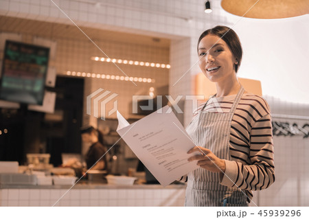 Appealing beautiful woman holding menu of her restaurant 45939296