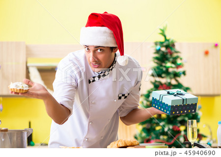 Young chef husband working in kitchen at Christmas eve  45940690