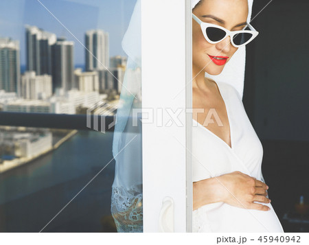 Pregnant woman on balcony Pregnant woman on balcony 45940942
