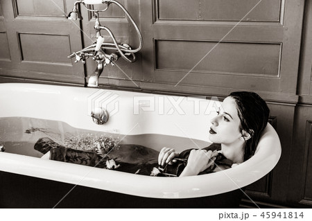 young woman in bath with flowers young woman in bath with flowers 45941814