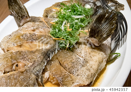 Fish in soy sauce, served on white plate Fish in soy sauce, served on white plate 45942357