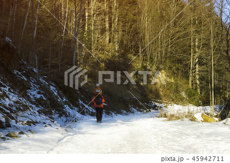 Man with son on shoulders walking along the road Man with son on shoulders walking along the road 45942711