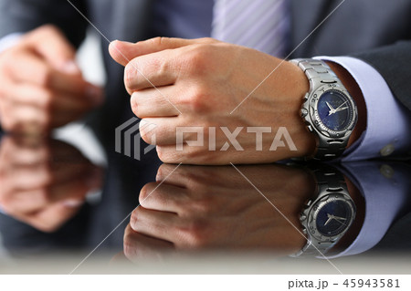 Man in suit and tie check out time at 45943581