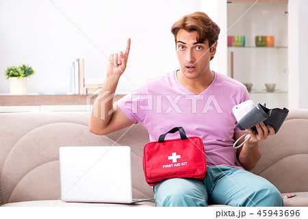Sick man at home with first aid kit Sick man at home with first aid kit 45943696