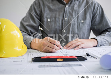 Construction engineering or architect hands working on blueprint 45944273