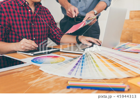 Teamwork of young creative designers working on project together 45944313