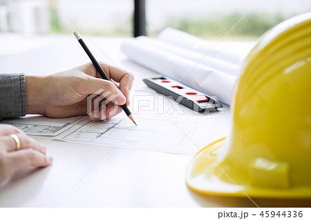 Construction engineering or architect hands working on blueprint 45944336