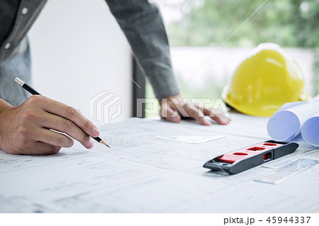 Construction engineering or architect hands working on blueprint 45944337
