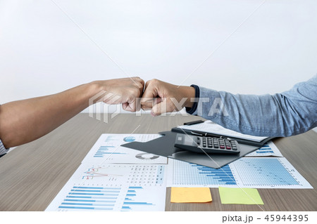 Finishing up a meeting, giving first bump of hand's two happy bu 45944395