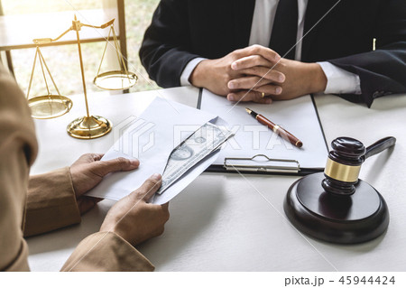 Business woman giving bribe money the form of dollar bills to ma 45944424