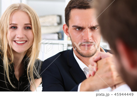 Two alpha man in suit hold hands in wrestle Two alpha man in suit hold hands in wrestle 45944449