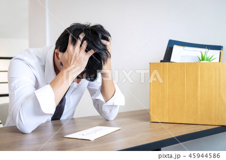 Stressed businessman will being resignation and packing belongin 45944586