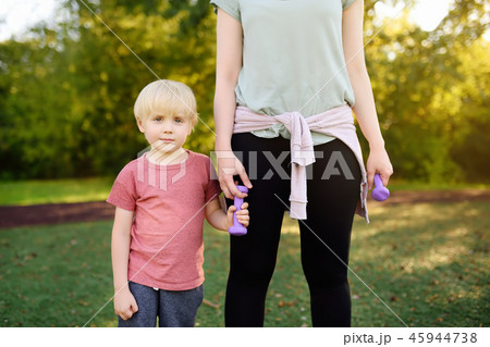 Little boy with mother in training with dumbbells. Little boy with mother in training with dumbbells. 45944738