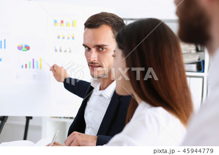 Group of people deliberate on white board 45944779
