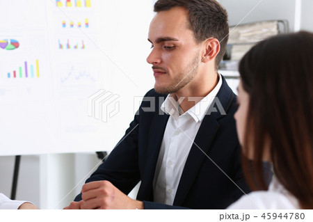 Group of people deliberate on white board 45944780