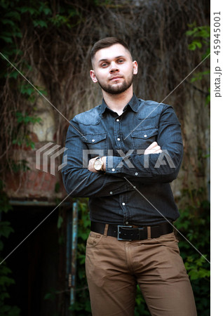 portrait of a Young man in a shirt and trousers 45945001
