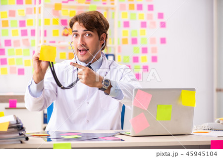 Male doctor with many conflicting prioritites  45945104