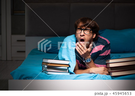 Young student preparing for exams at night at home Young student preparing for exams at night at home 45945653