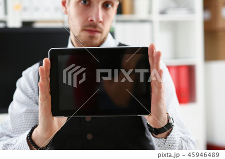 Male arm show tablet pc screen to camera closeup Male arm show tablet pc screen to camera closeup 45946489