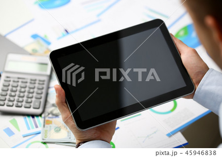Businessman holds tablet on background Businessman holds tablet on background 45946838