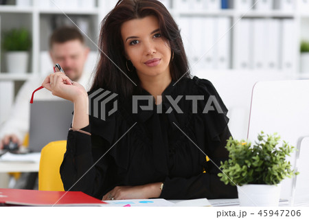 Beautiful smiling brunette woman sit at work table 45947206
