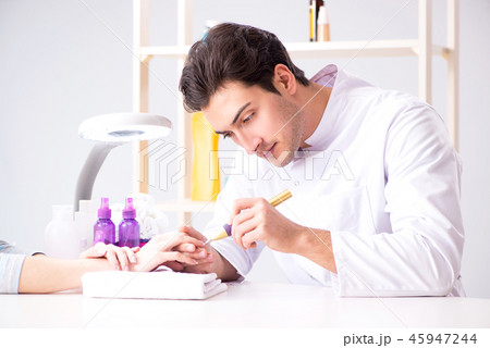 Hands during manicure care session Hands during manicure care session 45947244