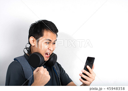 Excited man playing on smartphone 45948358