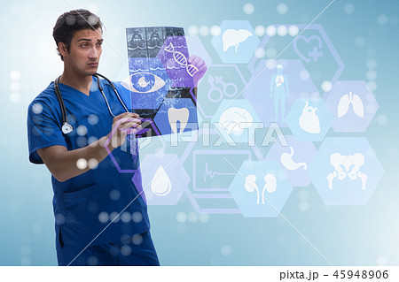 Young doctor looking at x-ray image in mhealth concept 45948906